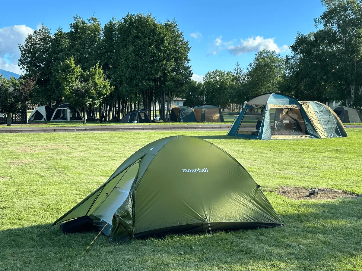 My green montbell tent on a green field.